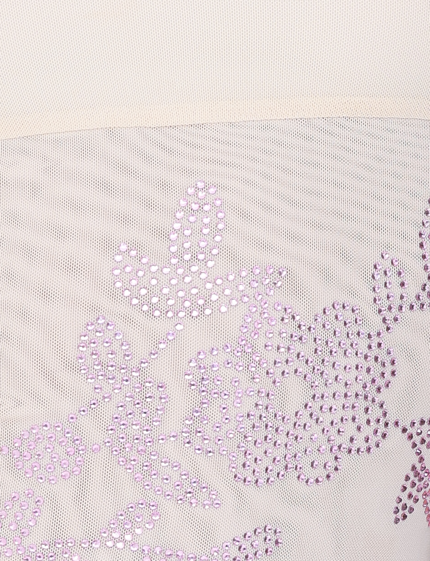 Close-up of the OCTAVIA TOP - NEUTRAL : CREAM by TIGERMIST, featuring sheer white mesh with light purple sequin floral and leaf patterns for a delicate, decorative look.